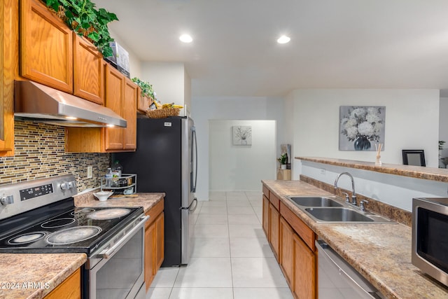 kitchen featuring sink, light tile patterned flooring, stainless steel appliances, decorative backsplash, and exhaust hood