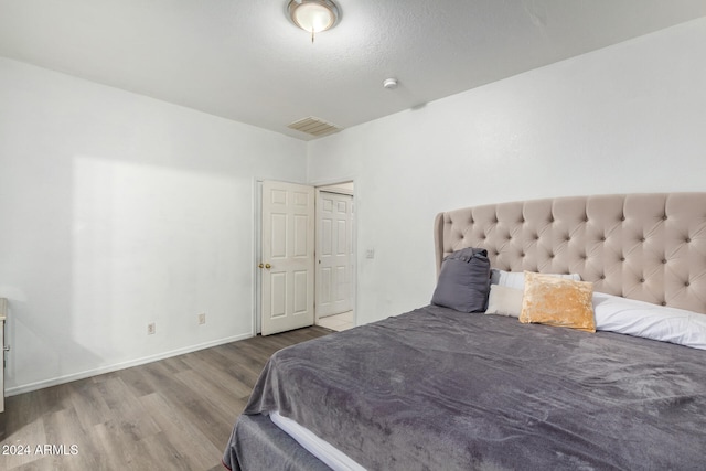 bedroom with wood-type flooring