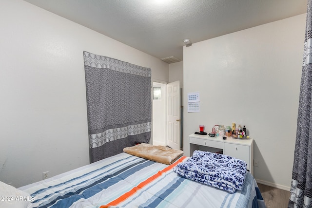 bedroom with hardwood / wood-style floors