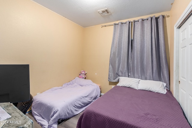 bedroom with a closet and a textured ceiling