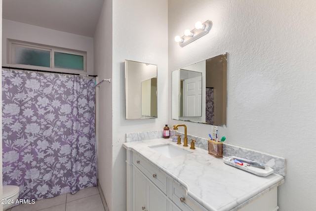 bathroom featuring vanity, walk in shower, toilet, and tile patterned floors