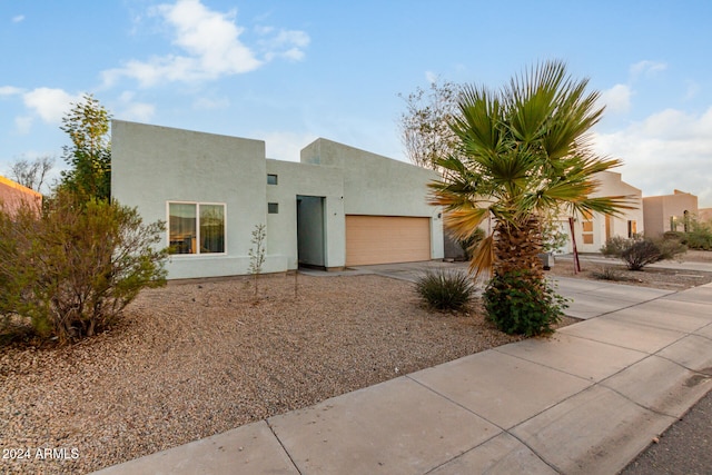 pueblo-style home featuring a garage