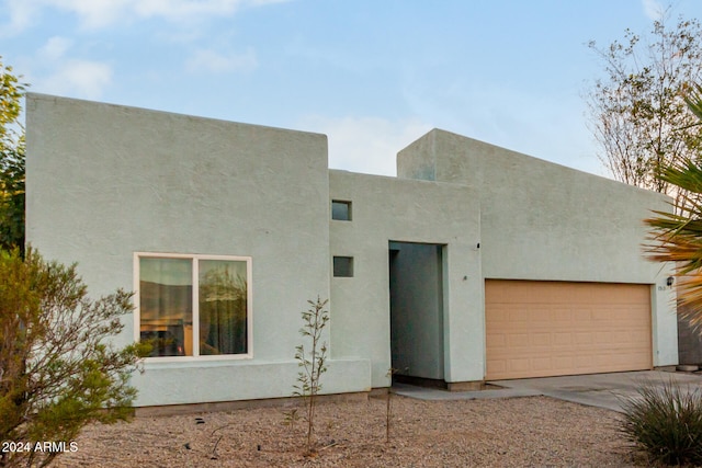 adobe home featuring a garage