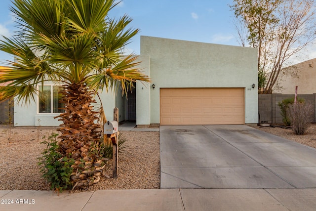 pueblo-style home with a garage