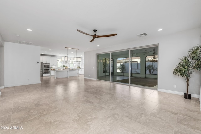 unfurnished living room featuring ceiling fan