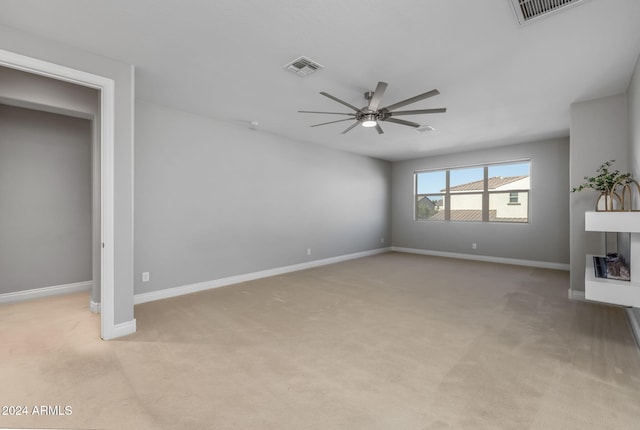 unfurnished living room featuring light colored carpet and ceiling fan