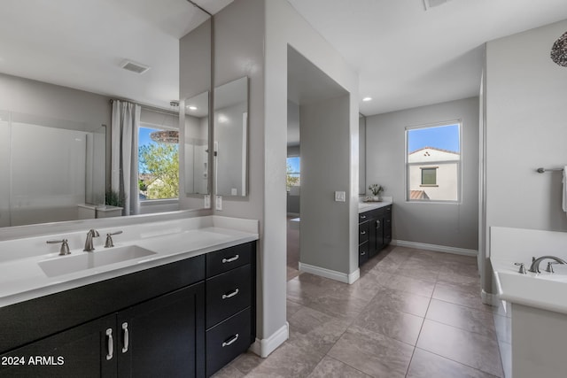 bathroom featuring vanity, tile patterned floors, and a wealth of natural light