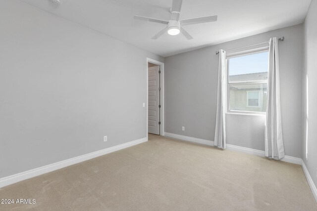 carpeted empty room with ceiling fan