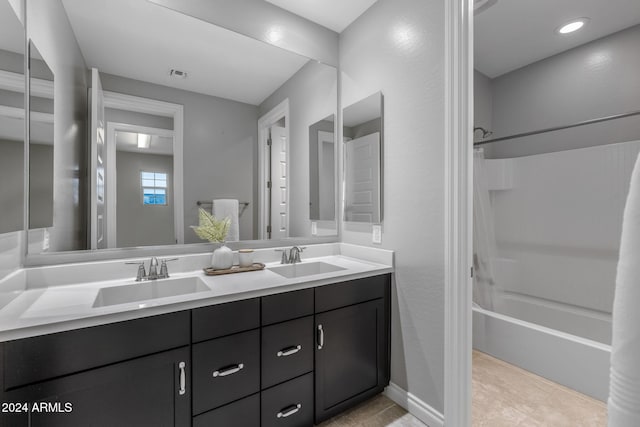 bathroom featuring shower / bathing tub combination, vanity, and tile patterned floors