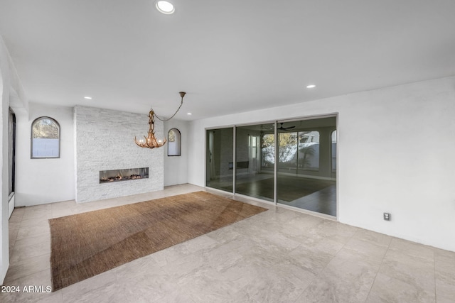 unfurnished living room with a stone fireplace