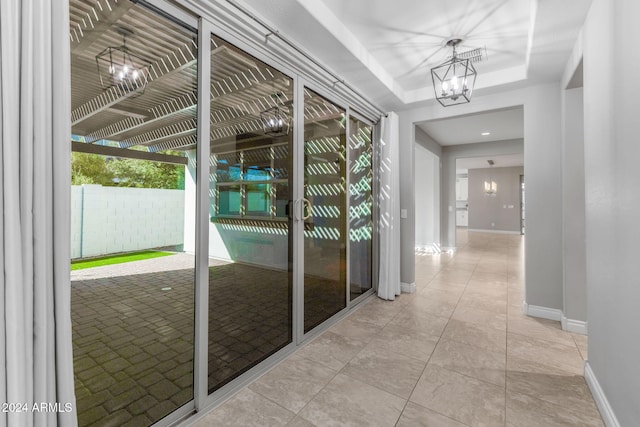 hallway featuring an inviting chandelier