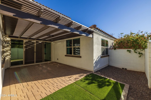 back of property featuring a pergola and a patio area