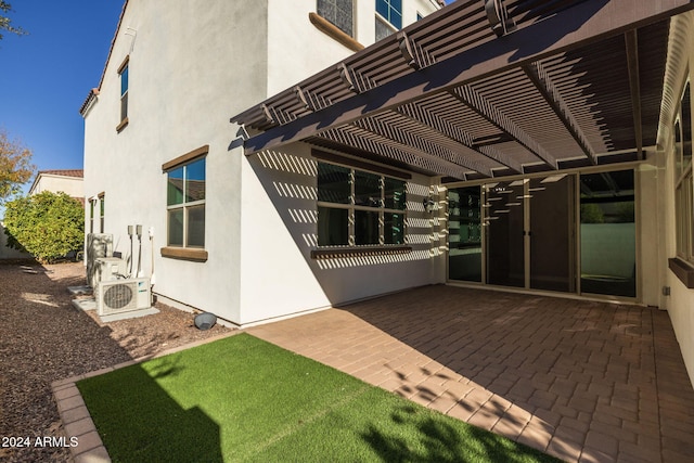 exterior space with ac unit, a pergola, and a patio