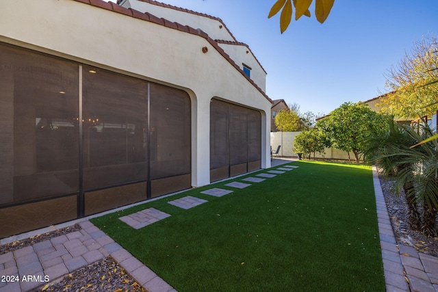 view of yard with a sunroom