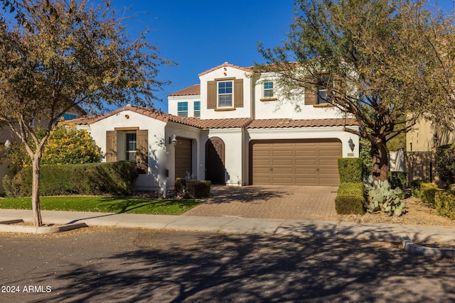 mediterranean / spanish home featuring a garage