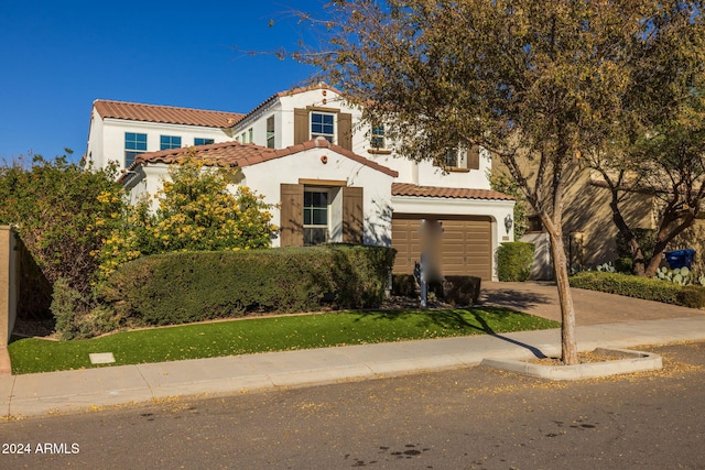 mediterranean / spanish home featuring a garage