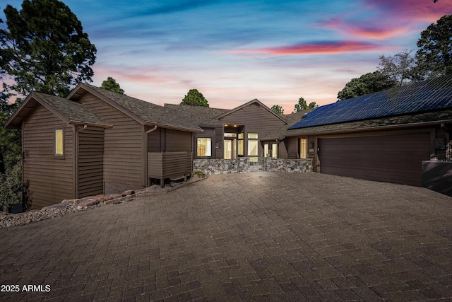 view of front facade featuring solar panels