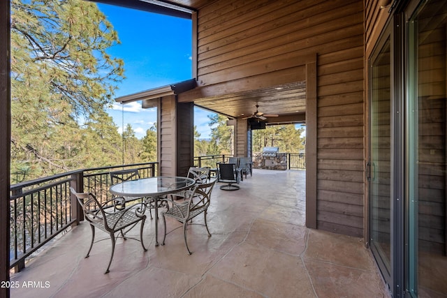 view of patio / terrace with ceiling fan and exterior kitchen