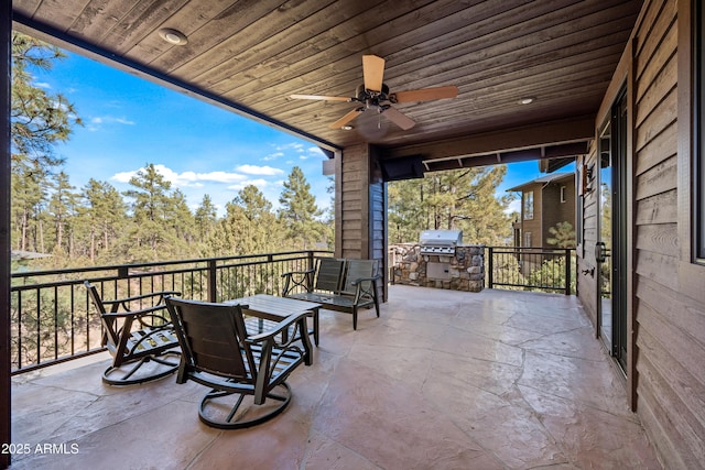 view of patio featuring grilling area, area for grilling, and ceiling fan