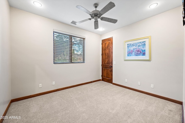 unfurnished room featuring ceiling fan and light carpet