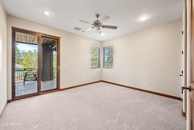 spare room with ceiling fan and light carpet