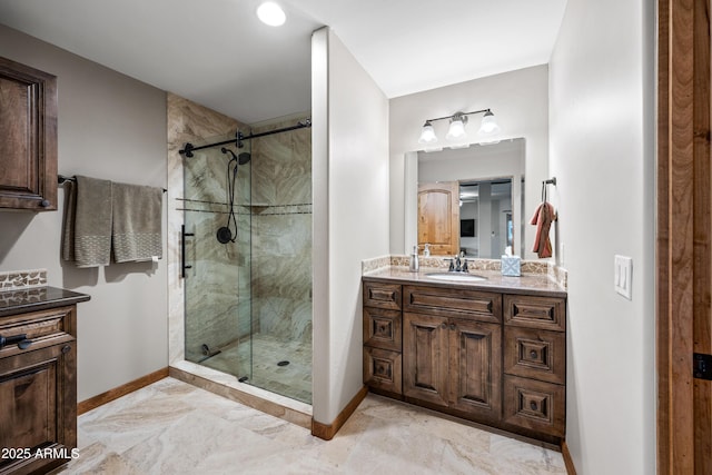 bathroom with vanity and a shower with shower door