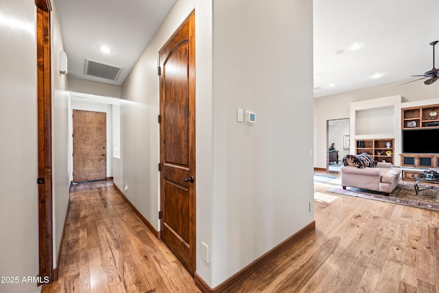 hall with light hardwood / wood-style floors