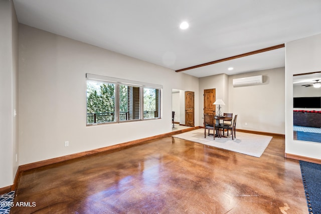 unfurnished room featuring a wall mounted AC and concrete floors