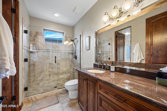 bathroom featuring vanity, toilet, and a shower with shower door