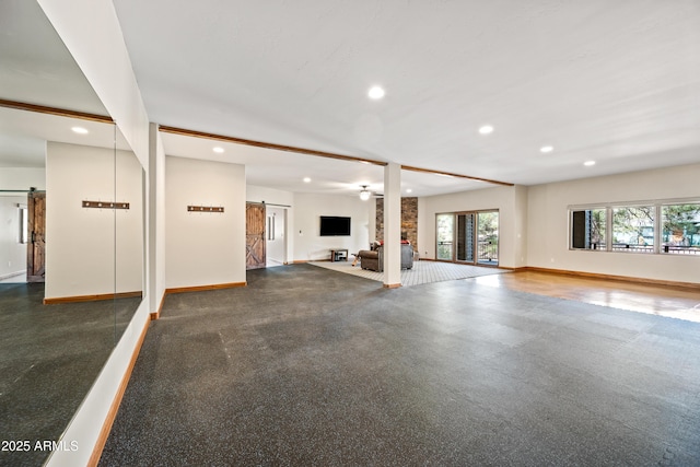 exercise room with a fireplace and a barn door