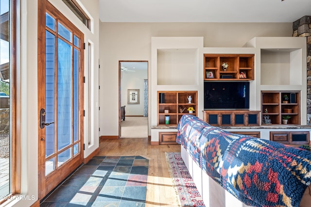 living room with built in features and dark hardwood / wood-style floors