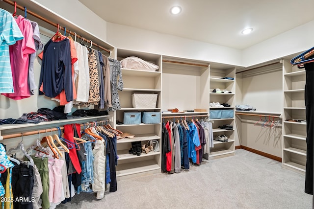 walk in closet with carpet