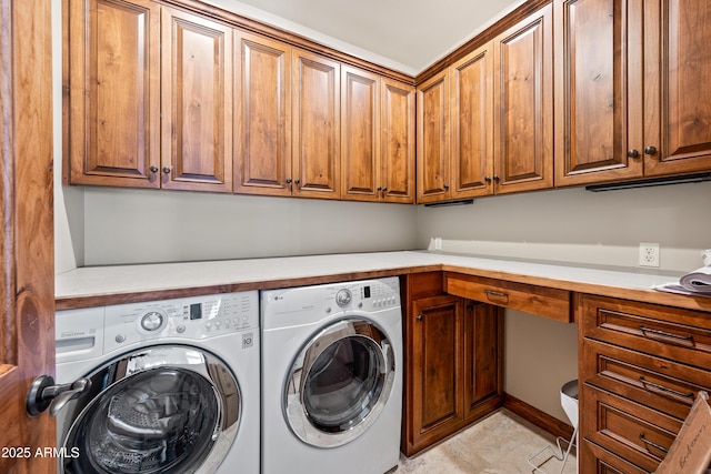 clothes washing area featuring cabinets and separate washer and dryer