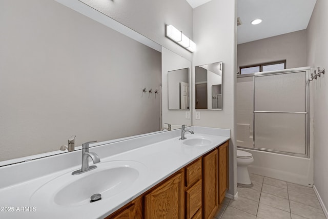 full bath with tile patterned flooring, a sink, double vanity, and toilet