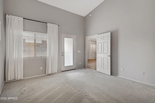 unfurnished bedroom featuring carpet flooring, baseboards, and multiple windows