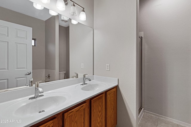 full bath featuring double vanity, visible vents, a sink, and tile patterned flooring