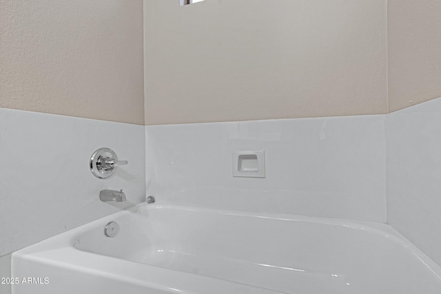 bathroom with a garden tub