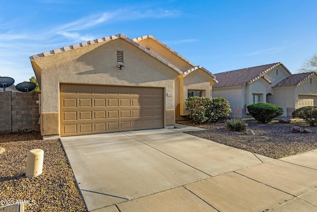 ranch-style house featuring stucco siding, driveway, and a garage