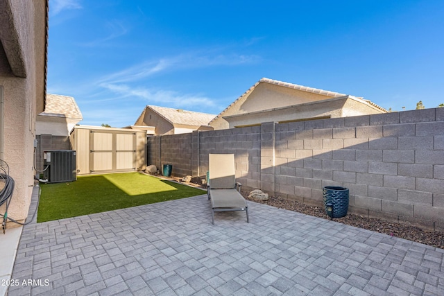 view of patio featuring an outdoor structure, central AC unit, a shed, and a fenced backyard