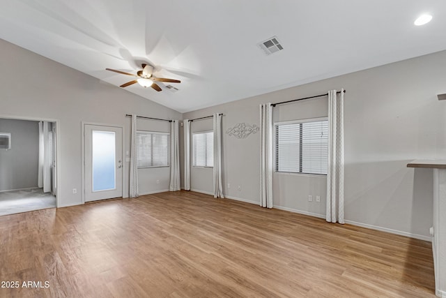 unfurnished living room featuring a ceiling fan, vaulted ceiling, visible vents, and light wood-type flooring