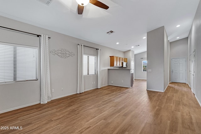 unfurnished living room featuring ceiling fan, visible vents, baseboards, and light wood-style floors