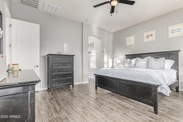 3884 S Wilson Dr, Chandler, AZ 85286 - bedroom with arched walkways, wood finished floors, and a ceiling fan