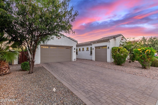 3884 S Wilson Dr, Chandler, AZ 85286 - mediterranean / spanish home featuring a garage, decorative driveway, stucco siding, and a tiled roof