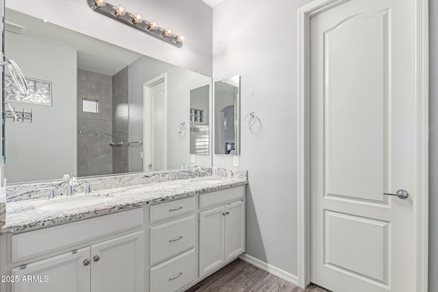 3884 S Wilson Dr, Chandler, AZ 85286 - bathroom with double vanity, wood finished floors, and a tile shower