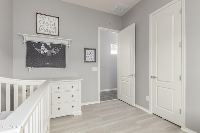 3884 S Wilson Dr, Chandler, AZ 85286 - bedroom with light wood-type flooring and a nursery area