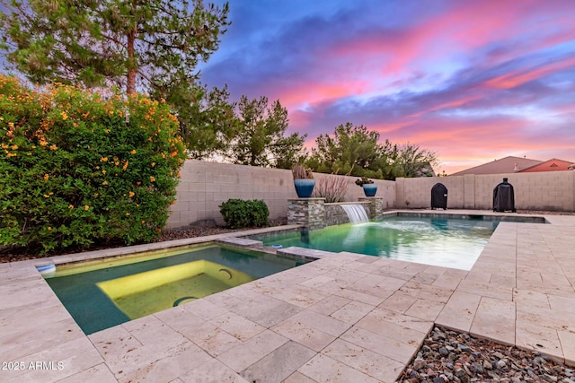 3884 S Wilson Dr, Chandler, AZ 85286 - pool at dusk with a patio area, a pool with connected hot tub, and a fenced backyard