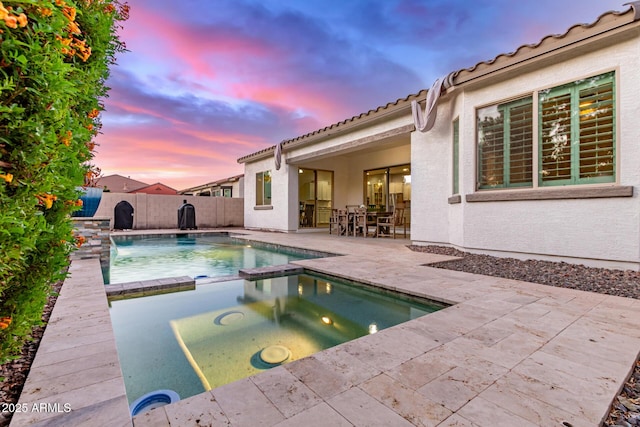 3884 S Wilson Dr, Chandler, AZ 85286 - pool at dusk with a patio, a fenced backyard, and a pool with connected hot tub