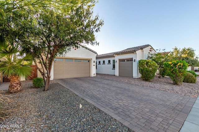3884 S Wilson Dr, Chandler, AZ 85286 - mediterranean / spanish-style house featuring a garage, decorative driveway, stucco siding, and a tile roof