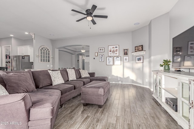 3884 S Wilson Dr, Chandler, AZ 85286 - living room featuring arched walkways, a ceiling fan, wood finished floors, and recessed lighting