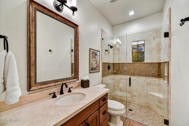 full bath featuring a stall shower, toilet, and vanity